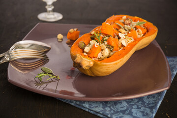 Butternut baked cut in half presented on a plate with old cutlery