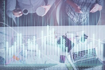 Double exposure of man and woman working together and financial chart hologram drawing. market analysis concept. Computer background. Top View.