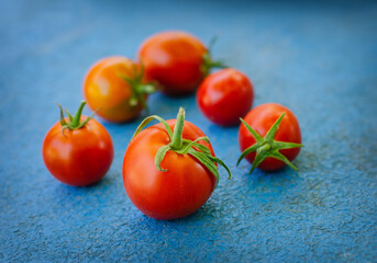 ripe red tomato berry on a blue background