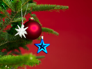Christmas ornaments on a Christmas tree on red background