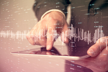 Multi exposure of man's hands holding and using a phone and financial chart drawing. Market...