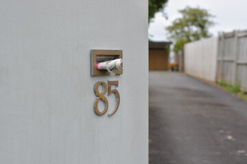 AUCKLAND, NEW ZEALAND - Nov 04, 2020: mailbox with junk mail sticking out