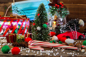 Christmas decoration other holidays symbol on table with face mask during COVID 19