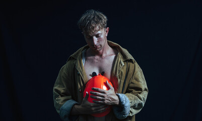 Man helmet. Dark background. Strong body man. male. Photo. Studio. 