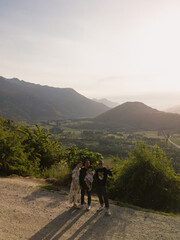 A family of 3 with a friend at the Arrow junction lookout during sunset.