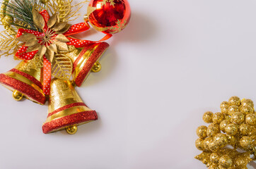 white christmas background with three  red golden bells and red balls and golden berries