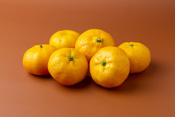 Small Oranges on table top with orange backgeound