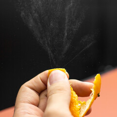 Orange peel skin oil splash with hand