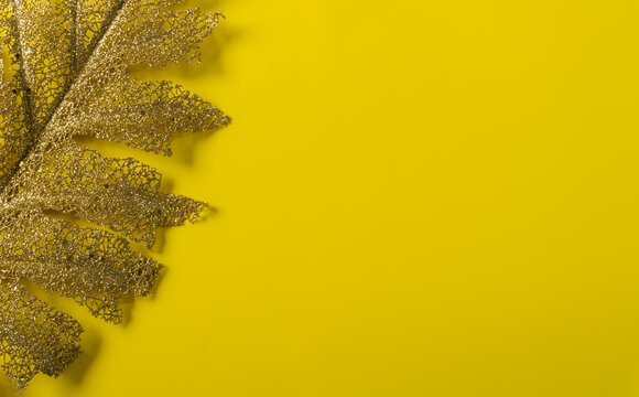 Yellow Christmas Background With Golden Leaf