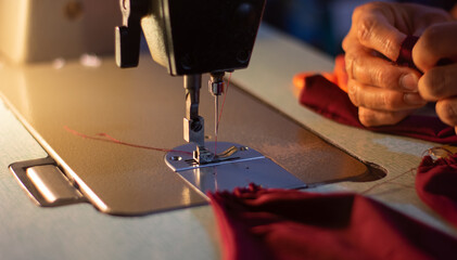 Closeup shot of a person working on a sewing machine