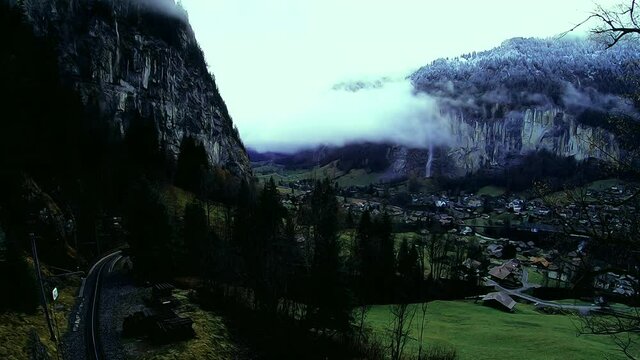 A time lapse of fog rolling through the valley in Lauterbrunnen, Switzerland with trains passing by