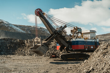 Electric excavator at the gold-mining site in the quarry.