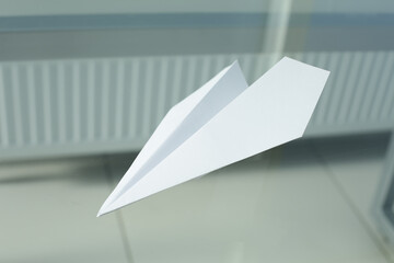 White plane lies on a glass table