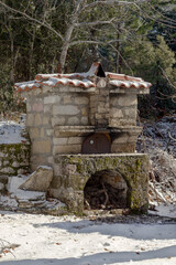 Greek, rustic, traditional, working, old stone stove for baking food in the outdoors on a winter...