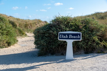 A sign marks an entrance pathway through the brush to Utah Beach in Normandy, France, where troops...