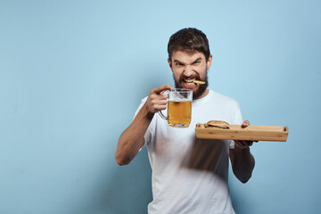 Cheerful man mug of beer fast food diet food lifestyle blue background alcohol