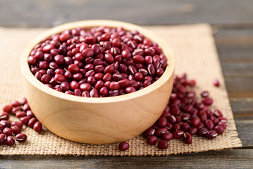 Azuki beans or red mung beans in a bowl on wooden table
