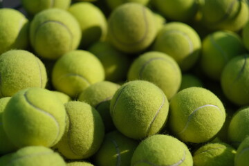 close up many tennis balls heap under sunlight