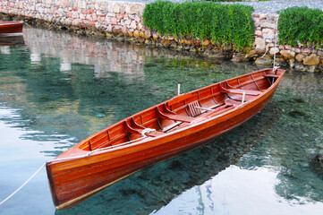 Row boat on very clear sea and its reflection