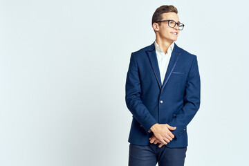 Business man wearing glasses blue suit cropped view official light background