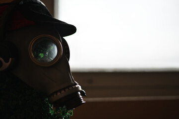 Antivirus protection concept. Photo of a gas mask with headphones on the head of a mannequin...