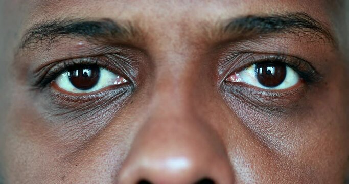 Tired black man eyes close-up looking at camera