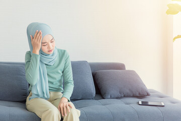 Arab Muslim Asian woman headache feel sick from using tablet.