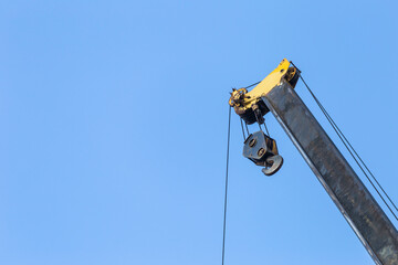 Top of pick and carry crane over clear blue sky background, construction industry concept