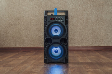 wireless bluetooth speaker with a flash drive stands on the floor in the house