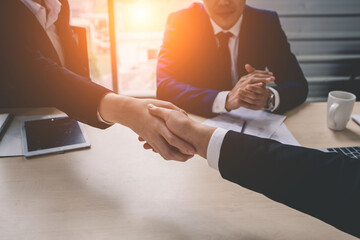 Business people shaking hands, finishing up meeting. Handshake Gesturing People Connection Deal Concept