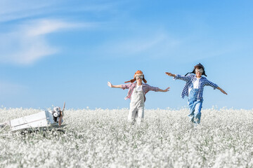 Young aviators with an airplane in the field