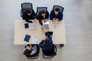 Business people shaking hands, finishing up meeting. Handshake Gesturing People Connection Deal Concept