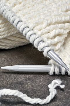 white wool knitted with spokes on gray background
