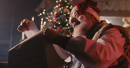 Santa Claus comparing letters with list