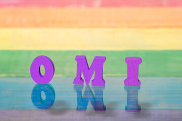 inscription omi on background of lgbt flag, wooden