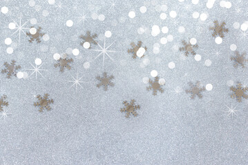 the silvery festive new year's background with silvery shining snowflakes lay flat. Christmas...