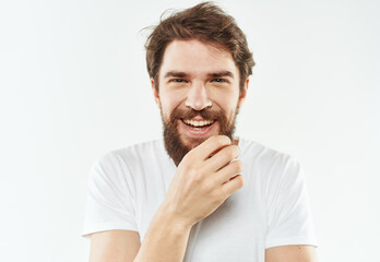 Energetic man in white t-shirt bushy beard gestures with hands cropped view