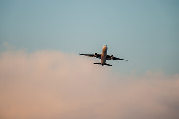 Passenger airplane flying above clouds. Travel concept, air travel