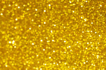 festive abstract blurry background with gold sequins.