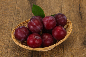 Plum heap in the wooden basket