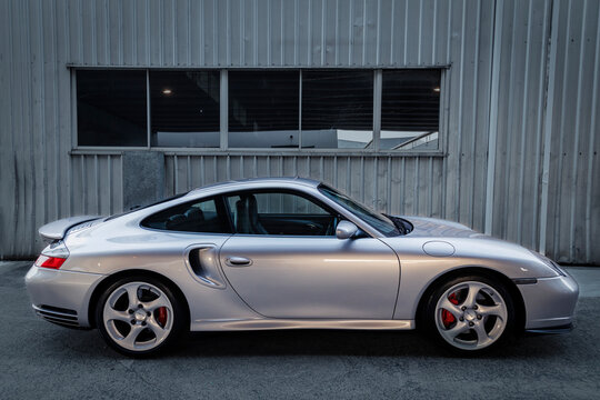 Brisbane, Queensland, Australia - February 29, 2020: Side view of a metallic silver Porsche 911, type 996 turbo S luxury German sports car coupe. This model was launched between 2001 and 2005. 