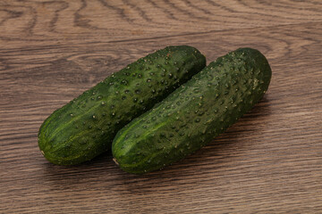 Green fresh cucumbers over background