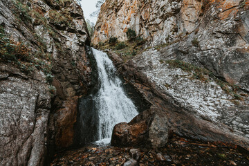 Small waterfall in mountain. Hiking and eco tourism in Caucasus mountain. Travel destinations.