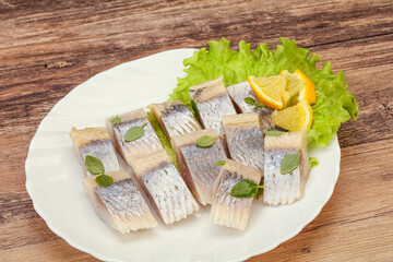 Herring fillet with sliced lemon