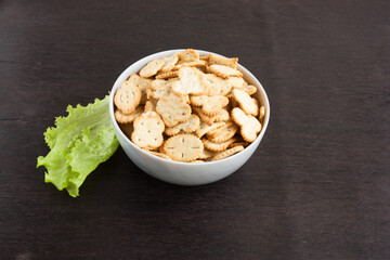 delicious dry cookies, biscuits, crackers with salt and herbs in a clay bowl