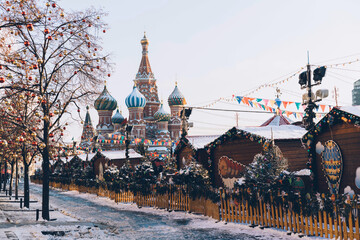 Christmas holidays, snowy winter landscape. Christmas fair on Festively decorated Red Square in snow. Christmas Market. Moscow, Russia.