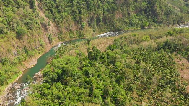 Aerial view of River in the mountains among the rainforest. Mindanao, Philippines. Cagayan de Oro river.
