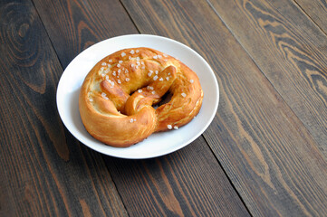 Hot fresh pretzel on a white plate