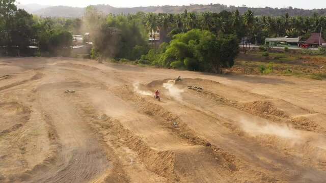 Aerial drone of motocross track with motorcycle racers training for competitions. Cagayan de Oro, Mindanao, Philippines.