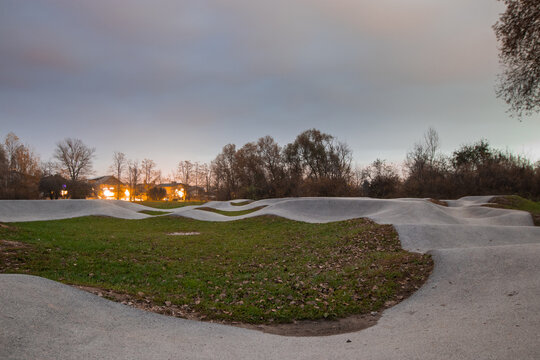 View of an empty pump track in evening hours. Popular pumptrack resting peacfully in the evening in fall.